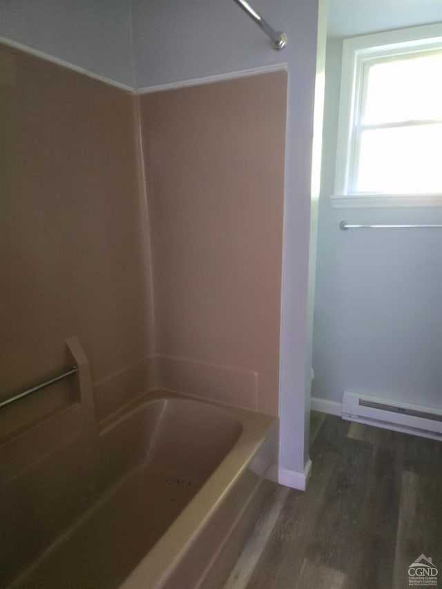 bathroom featuring hardwood / wood-style floors, shower / tub combination, and a baseboard heating unit