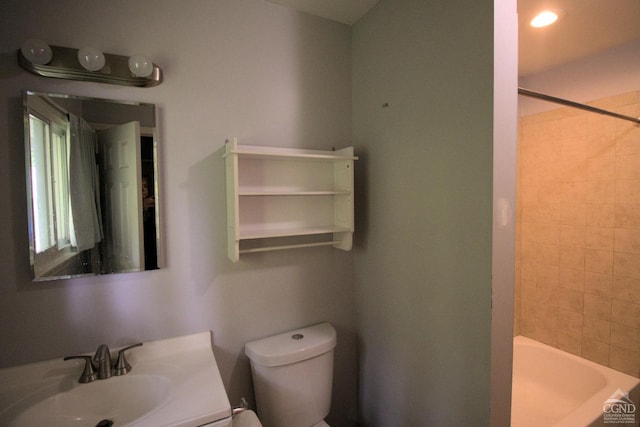 full bathroom featuring vanity, toilet, and tiled shower / bath