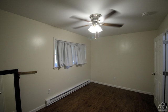 empty room featuring dark hardwood / wood-style flooring, a baseboard radiator, and ceiling fan