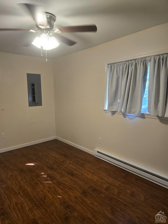 spare room featuring baseboard heating, electric panel, ceiling fan, and dark wood-type flooring