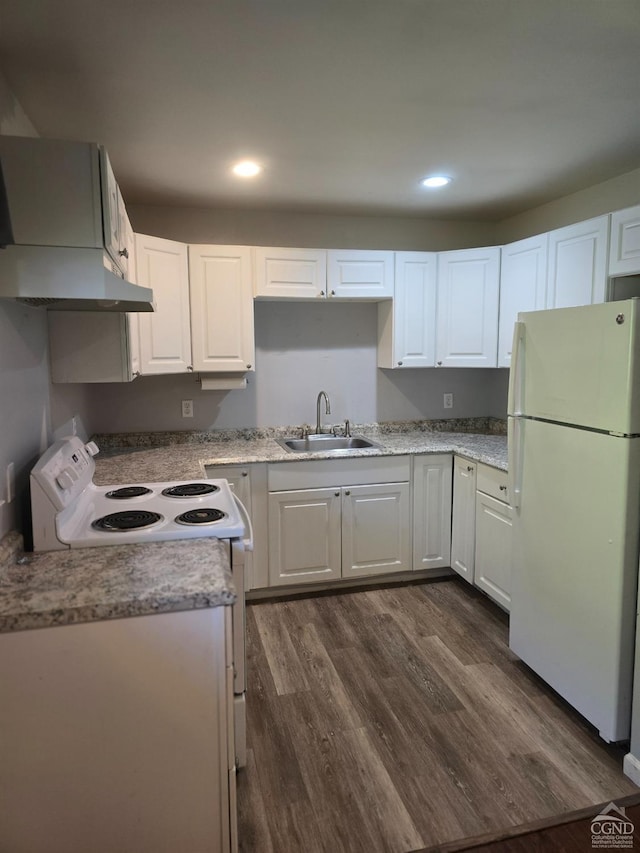 kitchen with dark hardwood / wood-style flooring, white appliances, wall chimney range hood, sink, and white cabinetry