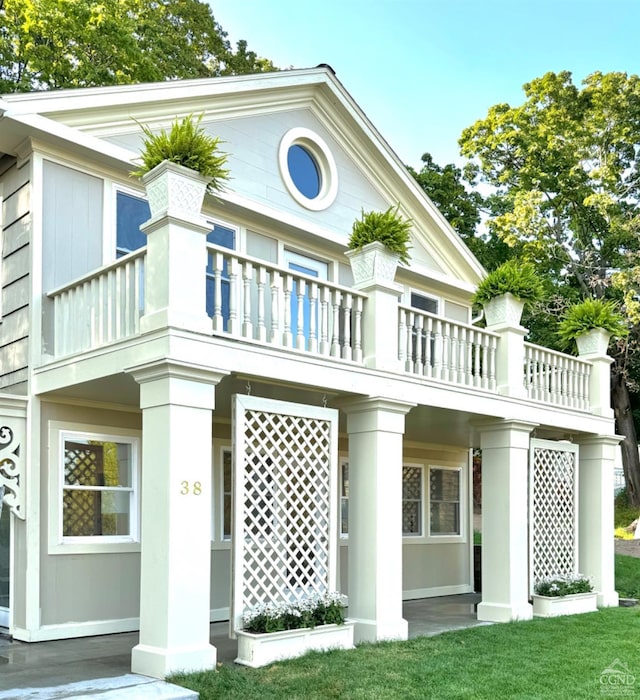 rear view of property featuring a balcony