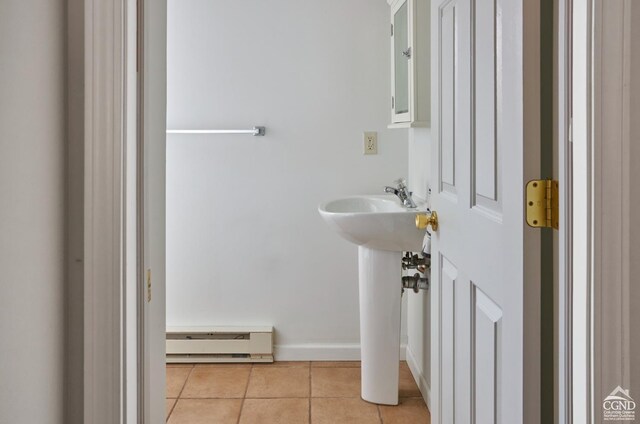 bathroom with tile patterned flooring and baseboard heating
