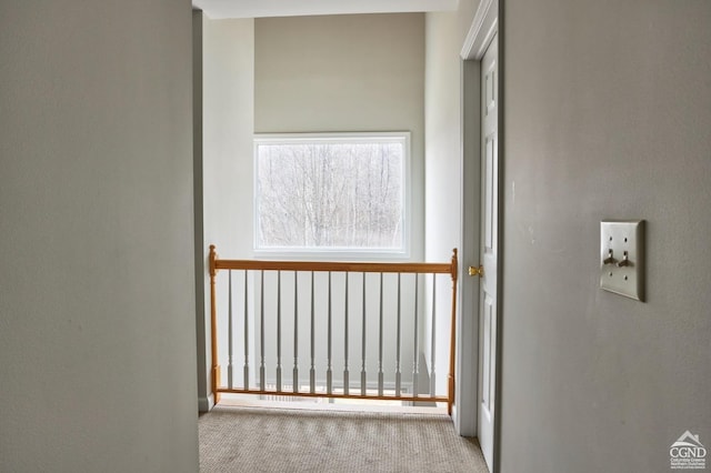 hallway with light colored carpet