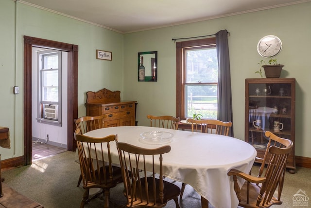 dining room with carpet floors and crown molding