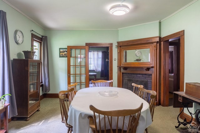 dining room with crown molding, a fireplace, and carpet floors