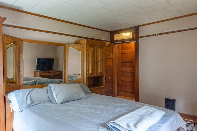 bedroom with crown molding