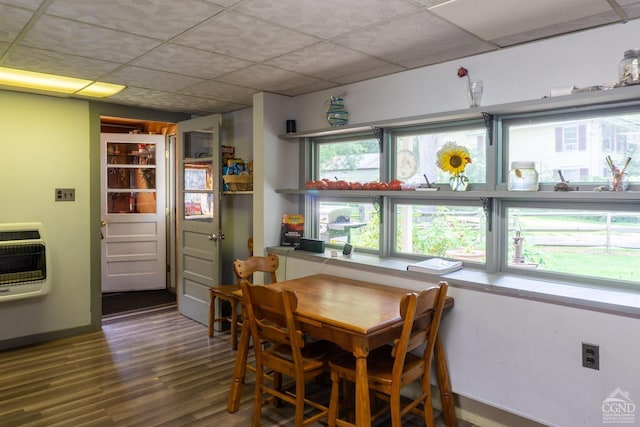 dining space featuring heating unit and hardwood / wood-style flooring