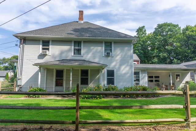 view of front of home with covered porch and a front lawn