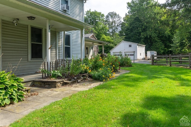 view of yard with an outbuilding, a porch, and a garage