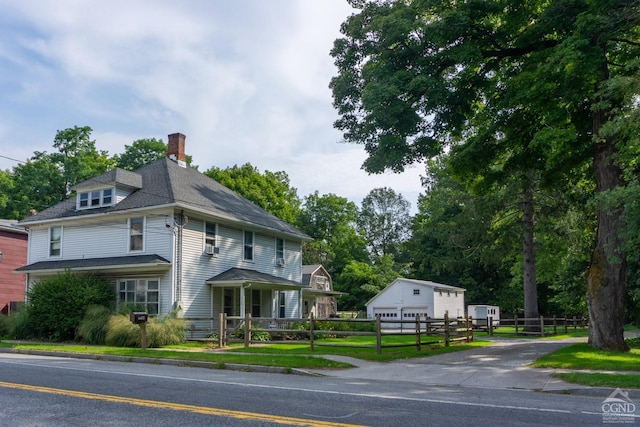 view of front of house with an outbuilding and a garage