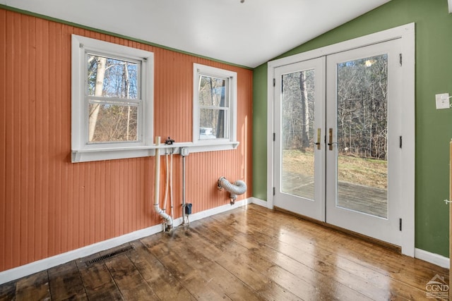 doorway to outside with french doors, hardwood / wood-style flooring, and lofted ceiling