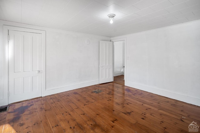 empty room featuring dark hardwood / wood-style flooring