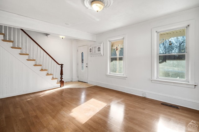 foyer entrance featuring hardwood / wood-style floors and ornamental molding