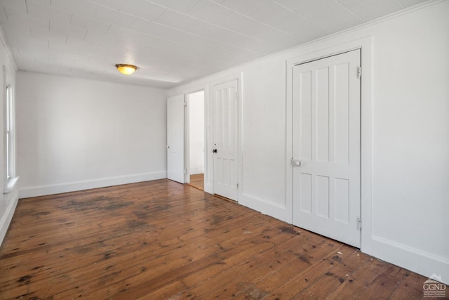 unfurnished bedroom featuring dark wood-type flooring