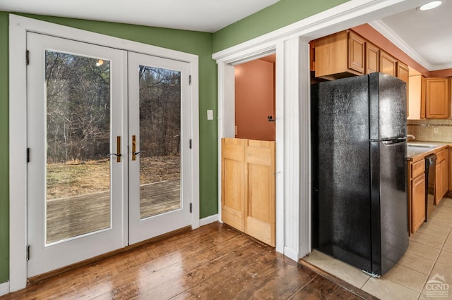 entryway featuring french doors, light hardwood / wood-style flooring, and a healthy amount of sunlight