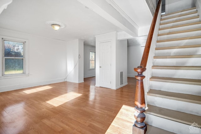 interior space featuring hardwood / wood-style flooring and crown molding