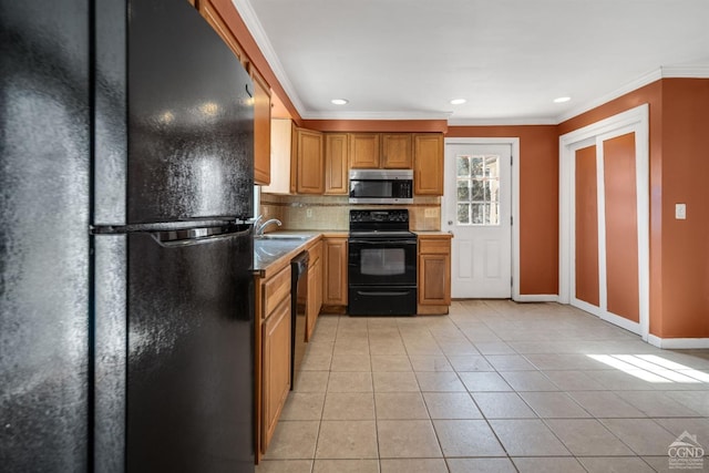 kitchen with sink, tasteful backsplash, crown molding, light tile patterned floors, and black appliances