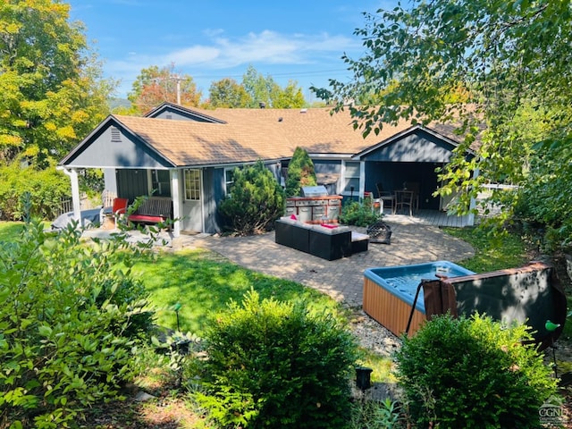 back of house with outdoor lounge area and a patio area