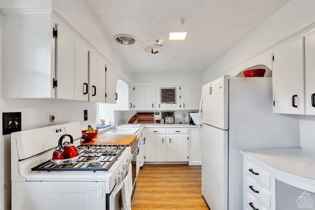 105 Gaf Lake Rd, Sanford, NY 13865 - kitchen with white appliances, light hardwood / wood-style floors, white cabinetry, and sink