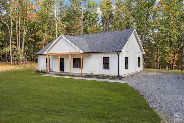 modern farmhouse style home with a porch and a front yard