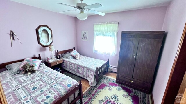 bedroom with ceiling fan and hardwood / wood-style floors