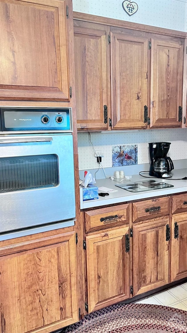 kitchen featuring wall oven and light tile patterned floors