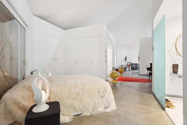 bedroom featuring a closet and finished concrete flooring