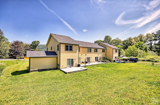 back of house featuring a lawn