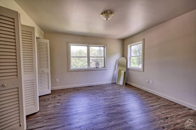 unfurnished bedroom with dark hardwood / wood-style flooring