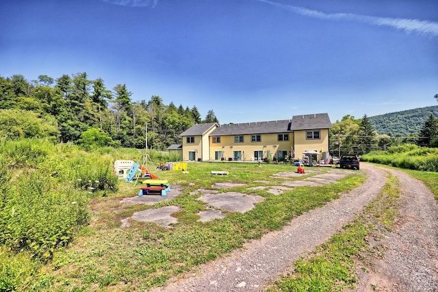 exterior space featuring a playground and a yard