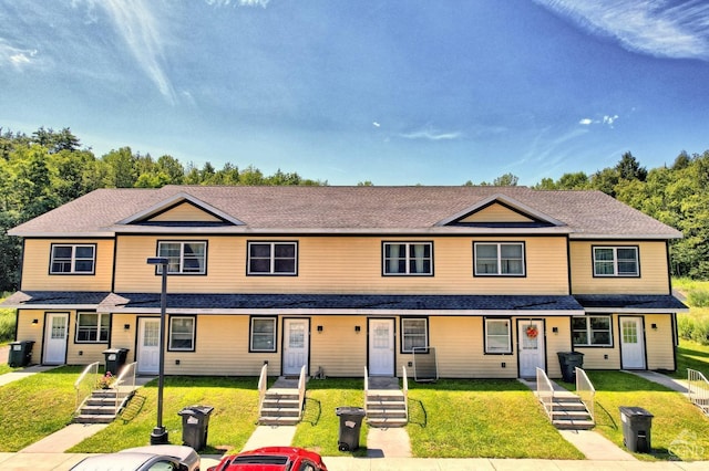 view of property featuring a front lawn