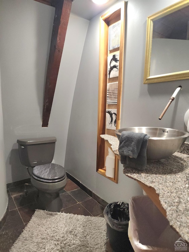 bathroom featuring sink, tile patterned flooring, and toilet