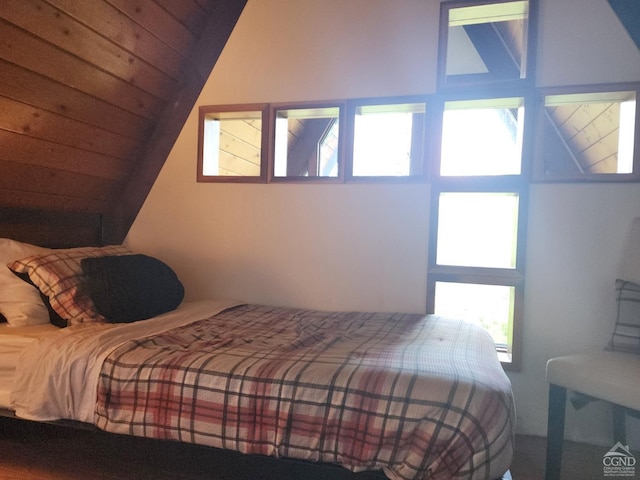 bedroom featuring multiple windows, wooden ceiling, and vaulted ceiling