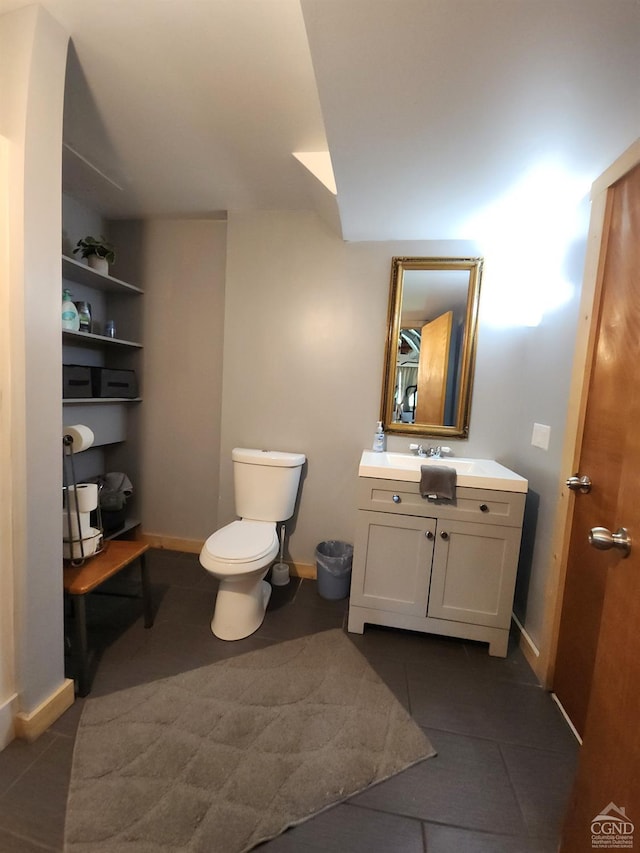 bathroom with tile patterned floors, vanity, and toilet