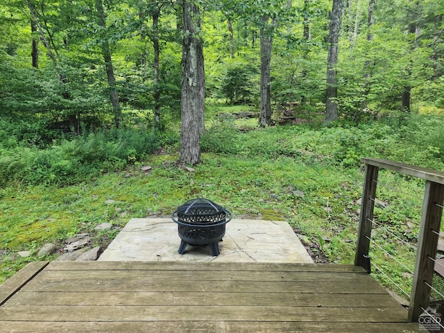 wooden deck featuring an outdoor fire pit