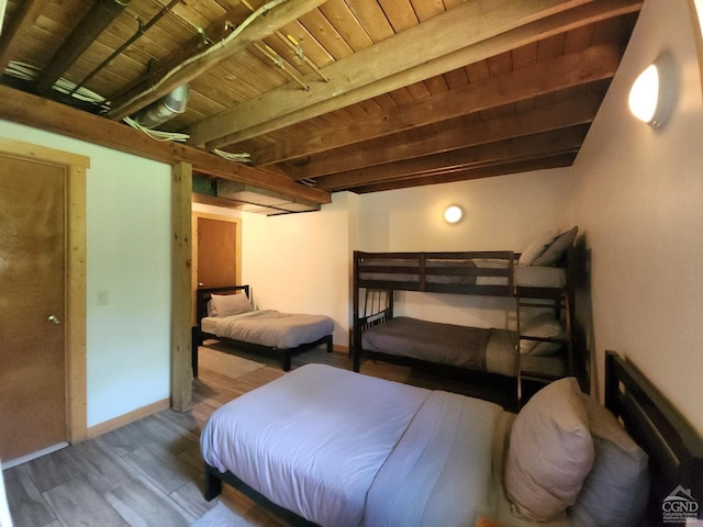 bedroom with beam ceiling, wood-type flooring, and wood ceiling