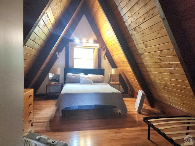 bedroom featuring wood walls, wooden ceiling, vaulted ceiling, and light wood-type flooring