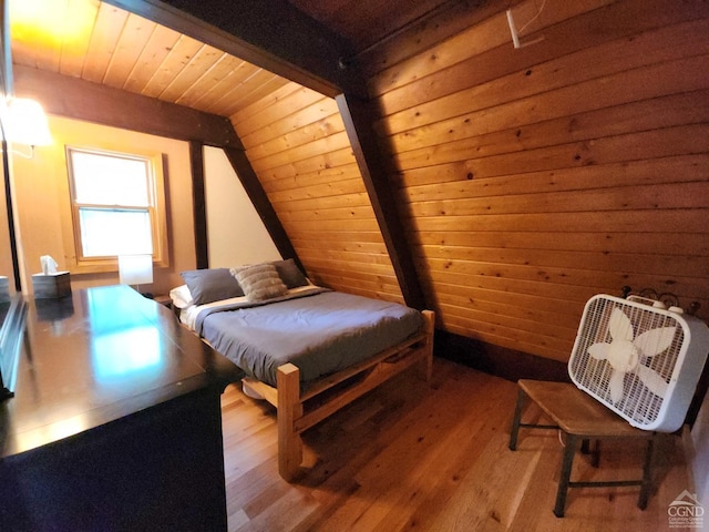 bedroom featuring vaulted ceiling with beams, light wood-type flooring, and wooden ceiling