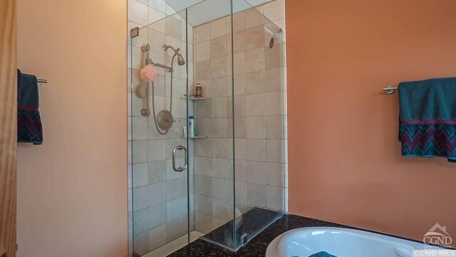 bathroom with a shower with door