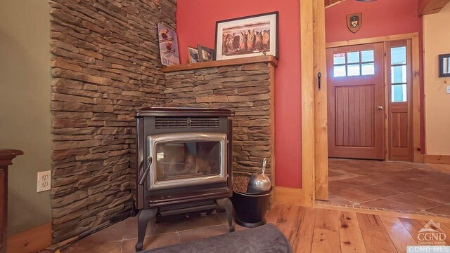 interior details featuring wood-type flooring and a wood stove