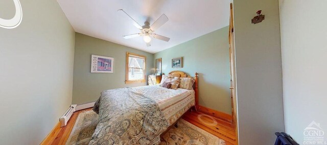 bedroom with hardwood / wood-style flooring, ceiling fan, lofted ceiling, and baseboard heating