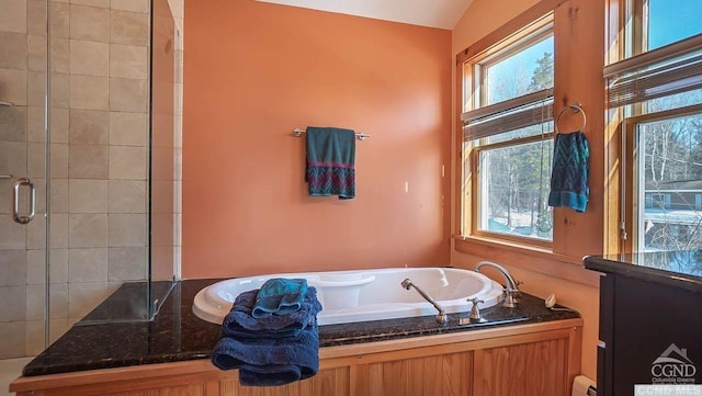 bathroom with a baseboard radiator, vaulted ceiling, and shower with separate bathtub