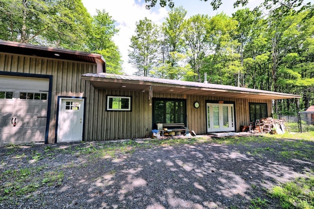 ranch-style home with a garage and french doors