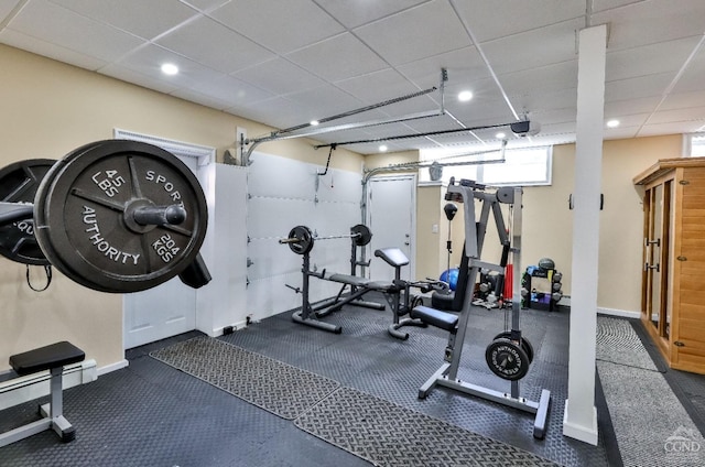 workout room with a drop ceiling and baseboard heating