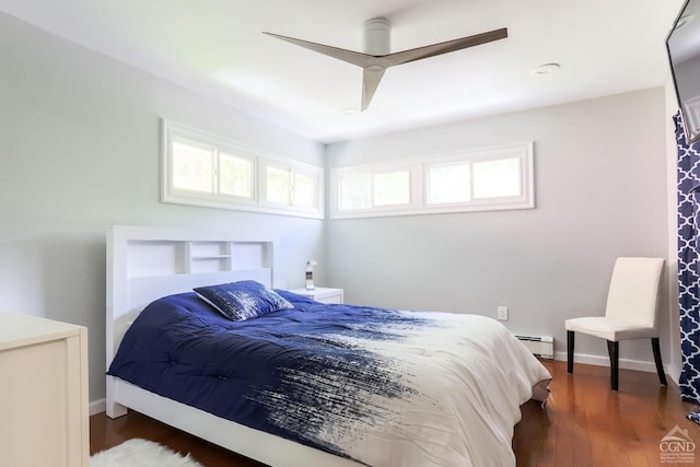 bedroom featuring dark hardwood / wood-style floors, a baseboard radiator, and ceiling fan