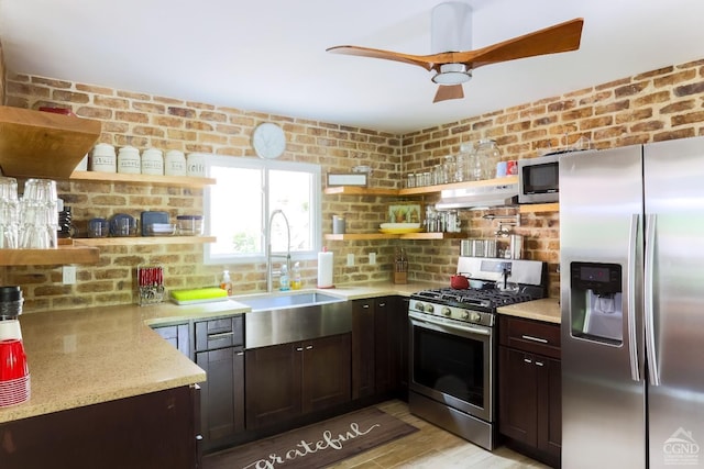 kitchen featuring dark brown cabinets, stainless steel appliances, sink, exhaust hood, and light hardwood / wood-style floors