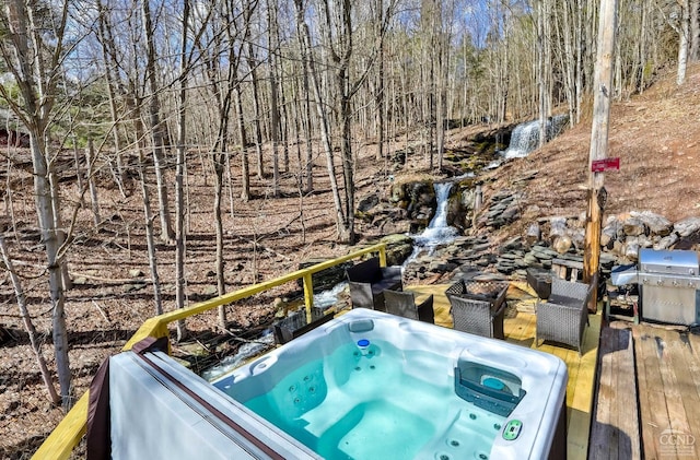 deck featuring grilling area and an outdoor hot tub