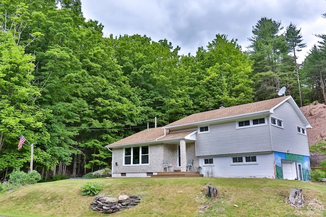 tri-level home with a front yard and a garage