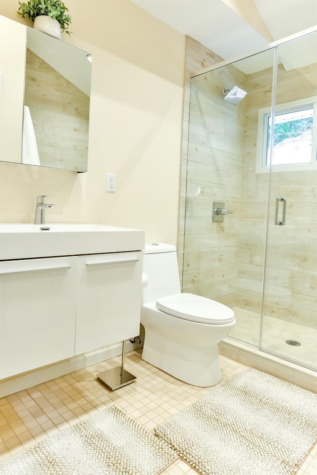 bathroom featuring tile patterned floors, toilet, vanity, and walk in shower